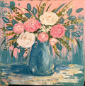Pink and cream roses arranged in a blue vase